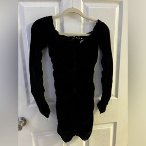 A black dress from Zara in the size xs